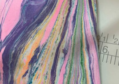 Close-up of water marbled textile showing blended pigment technique on twill fabric