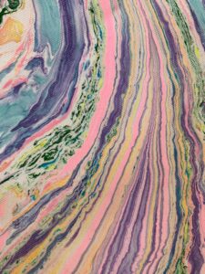 Abstract marbled fabric detail with flowing vertical color movement